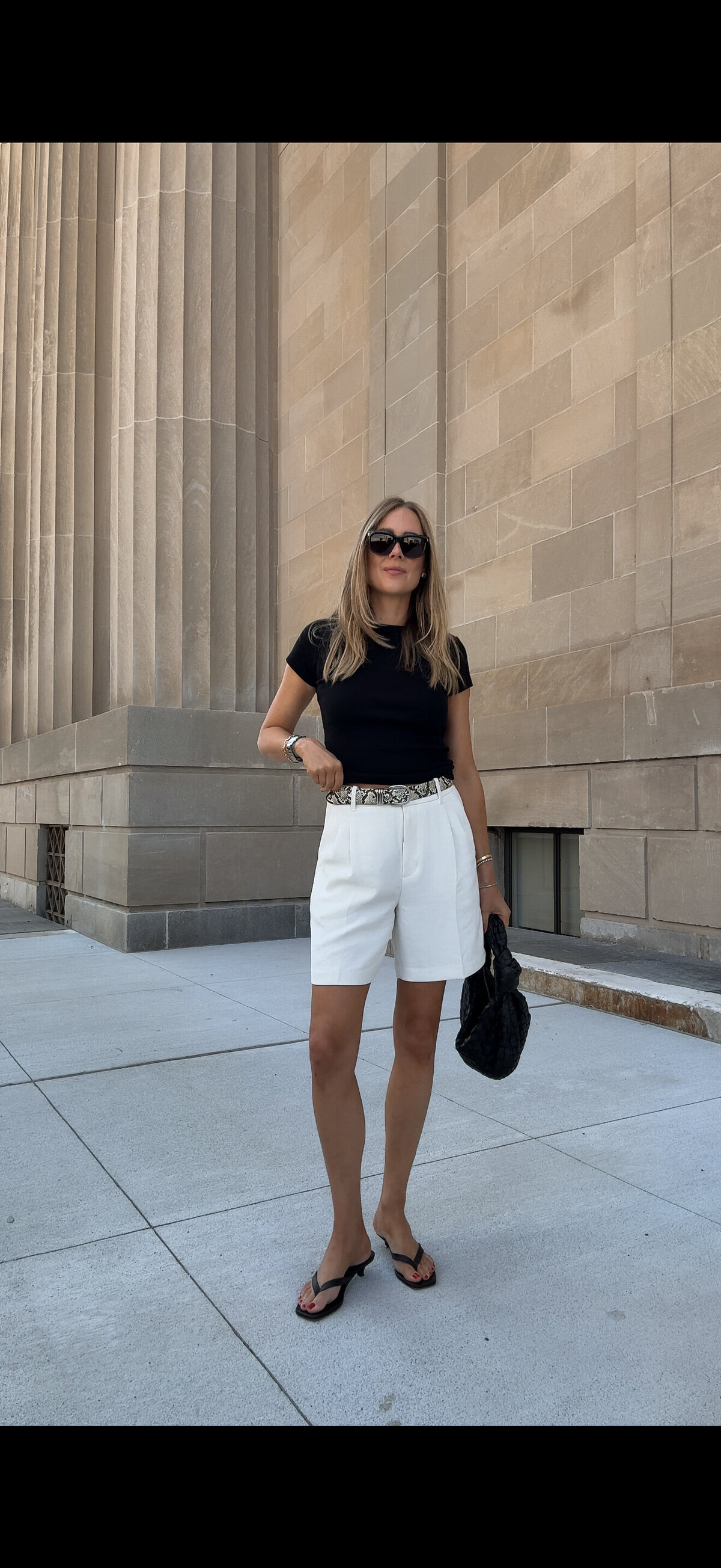 A black top and white shorts in the city